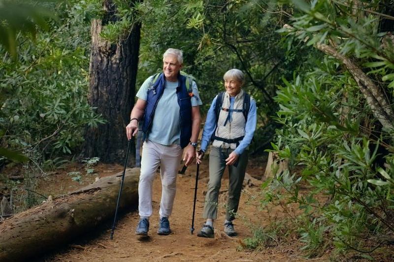 Older couple wlaking through the woods