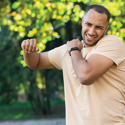 Man holding onto shoulder
