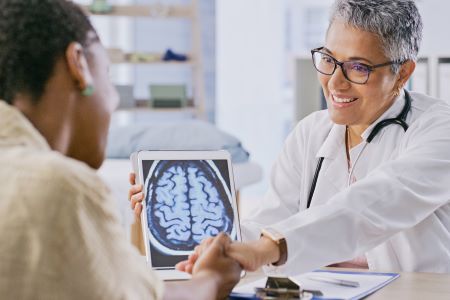 Woman and doctor looking at a brain scan