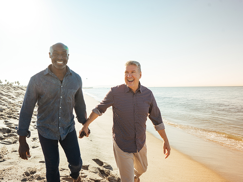 Diverse Pride Men walking on beach