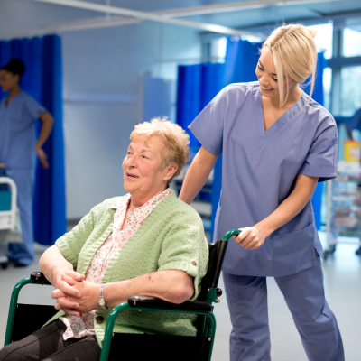 nurse wheeling patient